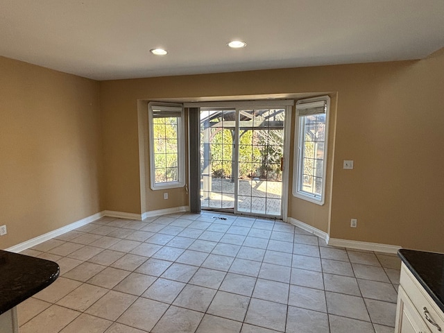 doorway with light tile patterned flooring, recessed lighting, and baseboards