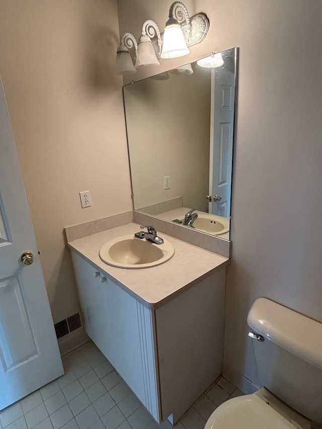 bathroom with tile patterned floors, visible vents, toilet, and vanity