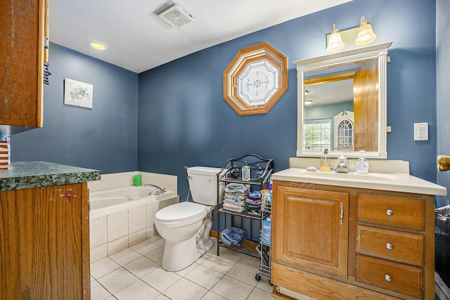 bathroom featuring toilet, vanity, visible vents, a bath, and tile patterned floors