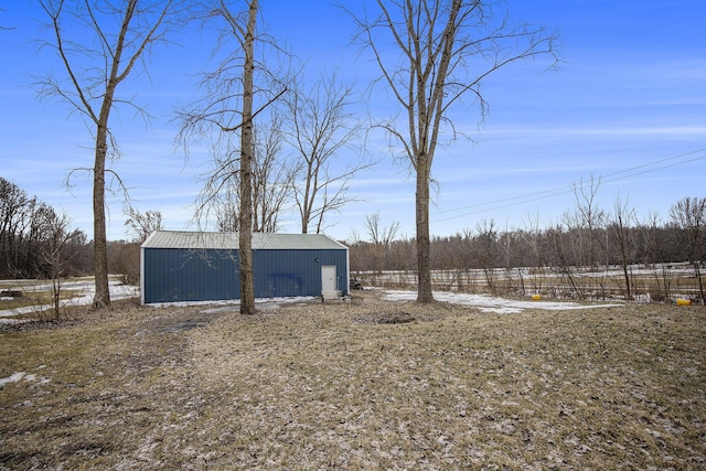 yard covered in snow with an outbuilding and a pole building