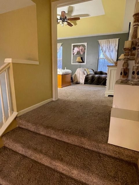 carpeted bedroom featuring baseboards and ceiling fan