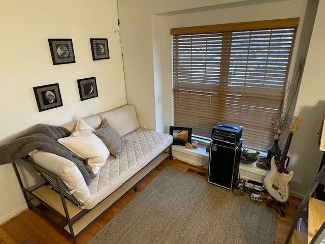 living area featuring baseboards and wood finished floors