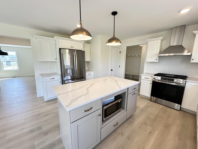 1846 Round Barn Dr, Hudsonville, MI 49426 - kitchen with wall chimney range hood, stainless steel appliances, light wood-style floors, and white cabinetry