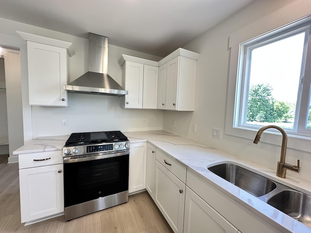 1846 Round Barn Dr, Hudsonville, MI 49426 - kitchen with gas stove, wall chimney exhaust hood, light wood-type flooring, and white cabinets