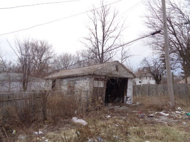 view of shed featuring fence