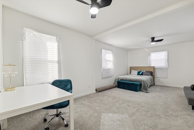 carpeted bedroom with ceiling fan, multiple windows, and baseboards