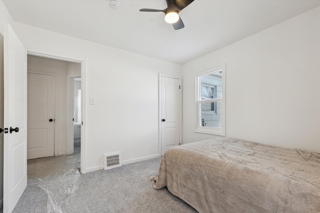 carpeted bedroom with ceiling fan, a closet, and baseboards