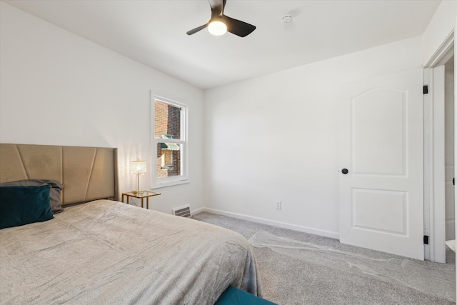 carpeted bedroom with visible vents, baseboards, and ceiling fan