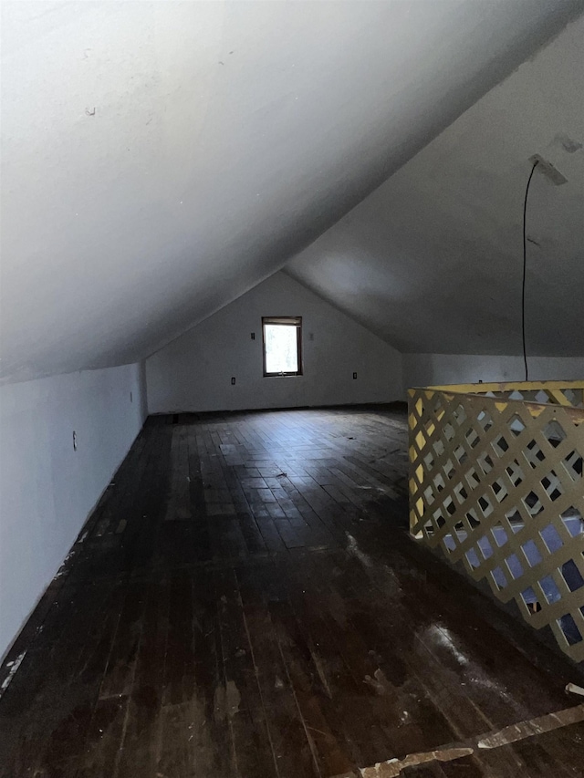 bonus room featuring wood-type flooring and vaulted ceiling