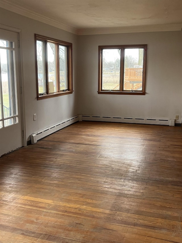 unfurnished room with ornamental molding, a healthy amount of sunlight, and hardwood / wood-style floors