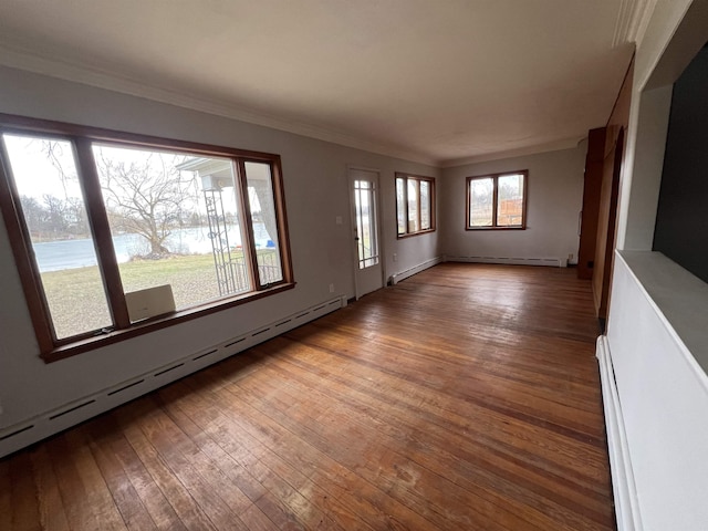 unfurnished living room featuring ornamental molding, a baseboard radiator, and wood-type flooring