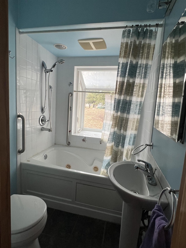 full bath with a sink, a combined bath / shower with jetted tub, and toilet