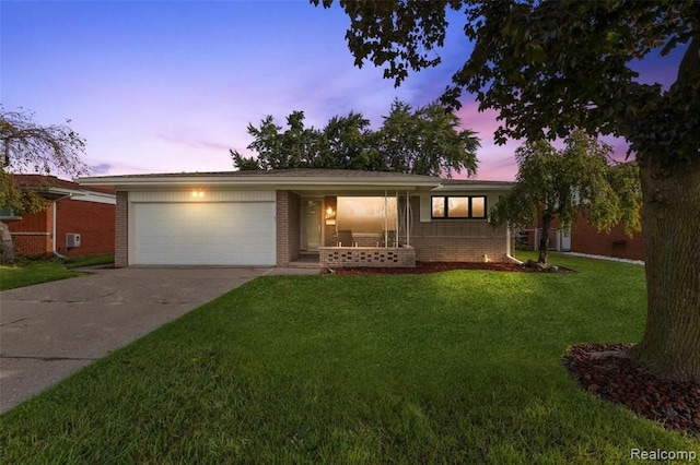 single story home with driveway, a garage, a front yard, a porch, and brick siding