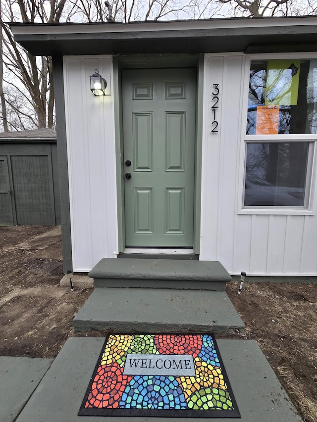 view of exterior entry featuring board and batten siding