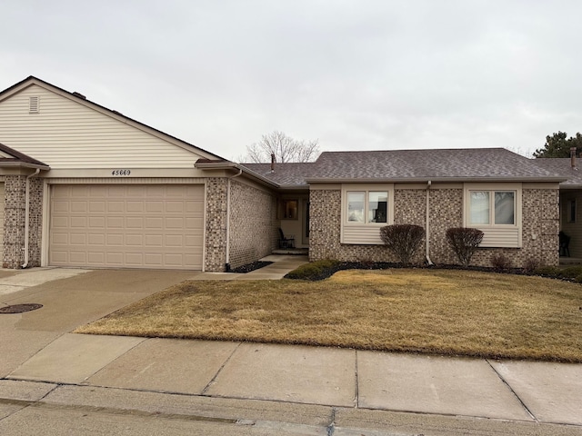 ranch-style house with a garage, concrete driveway, brick siding, and a front lawn