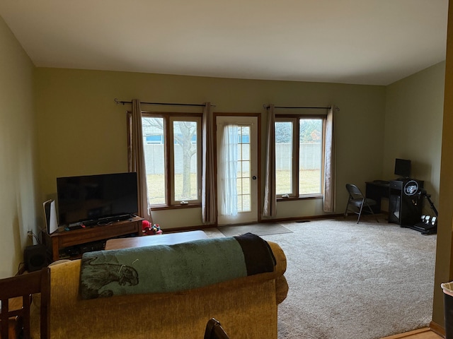 interior space with access to outside, baseboards, and light colored carpet