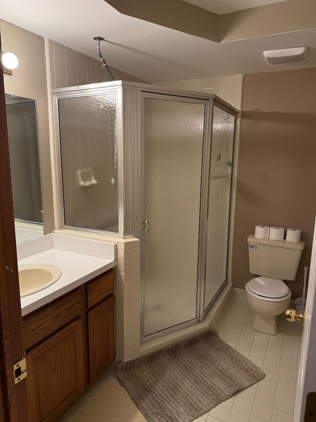 full bathroom featuring tile patterned flooring, toilet, visible vents, vanity, and a shower stall