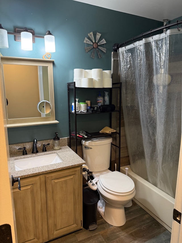 full bathroom with vanity, shower / bath combo with shower curtain, wood finished floors, and toilet