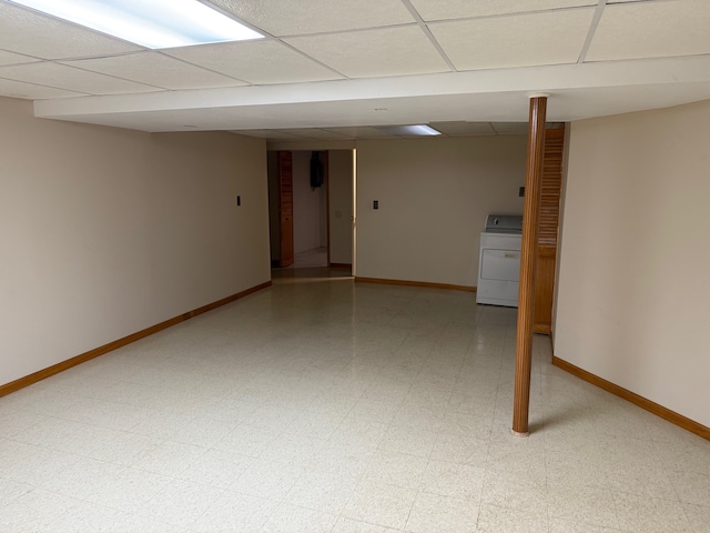 finished basement with washer / dryer, baseboards, a drop ceiling, and light floors