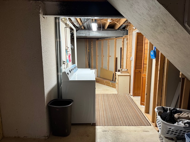 unfinished basement with washer and clothes dryer