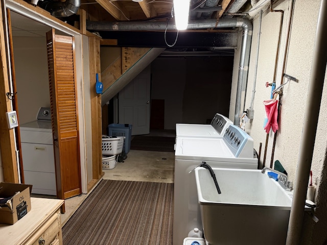 unfinished below grade area with a sink and independent washer and dryer