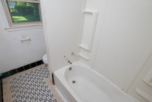 bathroom featuring toilet and tile patterned floors