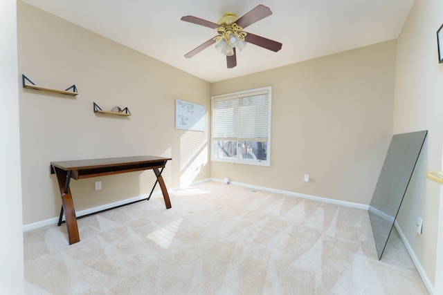 interior space featuring baseboards, a ceiling fan, and carpet flooring