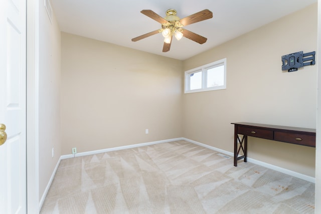 spare room with a ceiling fan, visible vents, carpet, and baseboards