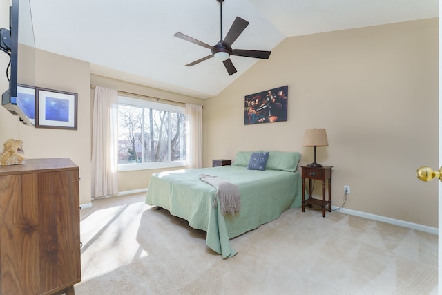 bedroom featuring baseboards, lofted ceiling, and carpet