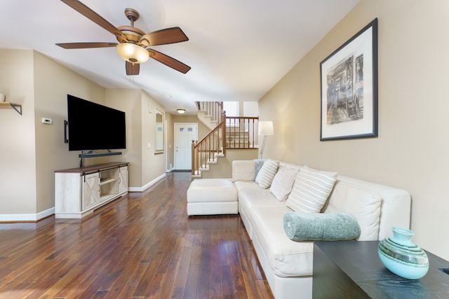 living area featuring ceiling fan, stairs, baseboards, and wood-type flooring