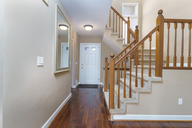 foyer entrance featuring baseboards and hardwood / wood-style floors