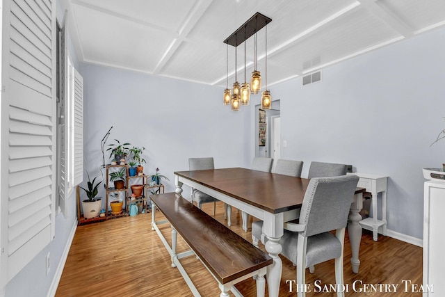 dining room with light wood-style floors, visible vents, a notable chandelier, and baseboards