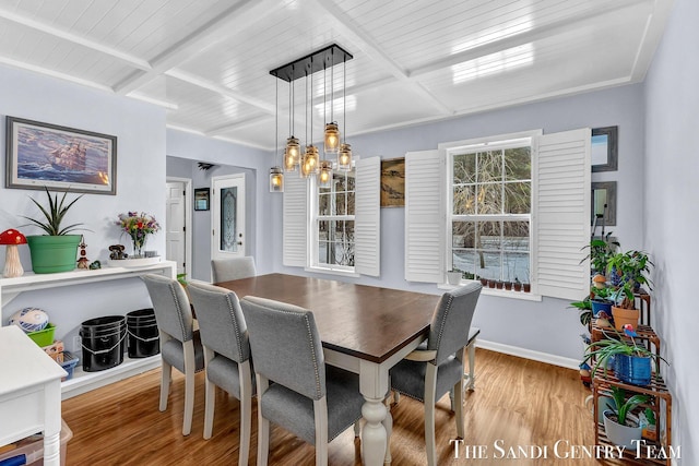 dining area with beamed ceiling, an inviting chandelier, wood finished floors, and baseboards