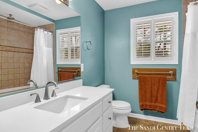 bathroom with a shower with curtain, vanity, toilet, and tile patterned floors