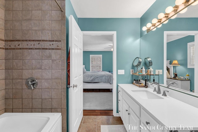 ensuite bathroom with tile patterned flooring, vanity, a ceiling fan, shower / bathing tub combination, and ensuite bath