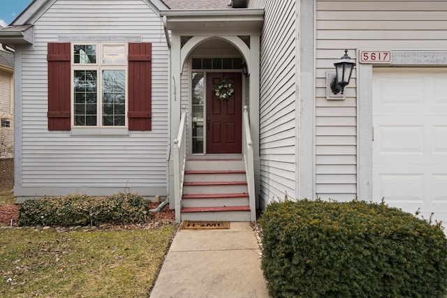 view of exterior entry with a garage