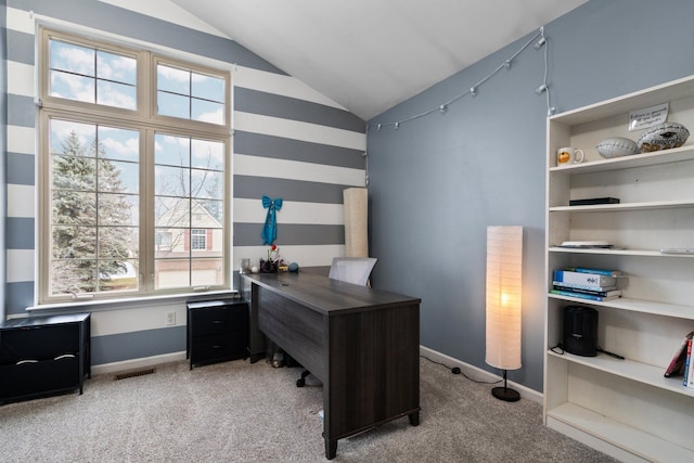 office space featuring vaulted ceiling, baseboards, visible vents, and light colored carpet