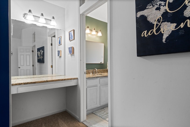 bathroom with vanity and baseboards