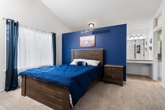 carpeted bedroom featuring lofted ceiling, baseboards, and visible vents