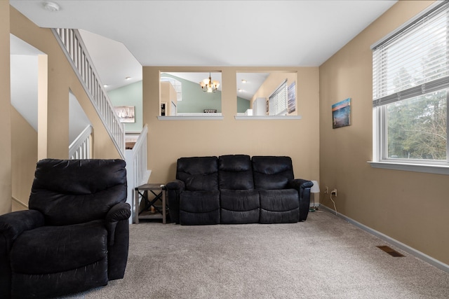 carpeted living room featuring lofted ceiling, stairs, baseboards, and a notable chandelier