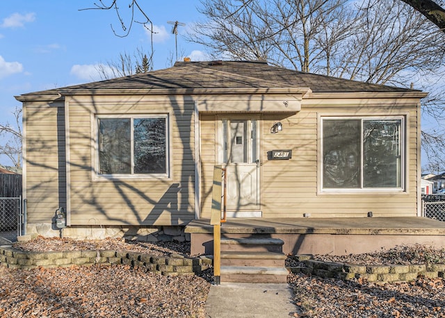 bungalow-style house with fence