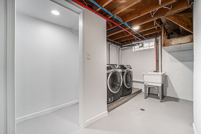 laundry room featuring laundry area, washer and clothes dryer, and baseboards