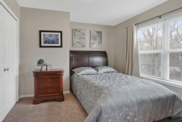 bedroom featuring carpet floors, a closet, and baseboards