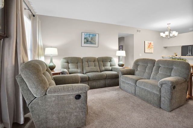 carpeted living room with visible vents and a notable chandelier