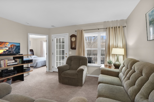 living area with baseboards and carpet flooring