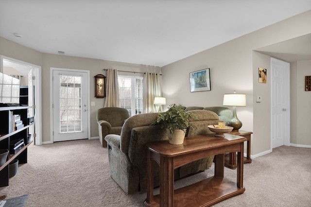 living area with visible vents, baseboards, and carpet flooring