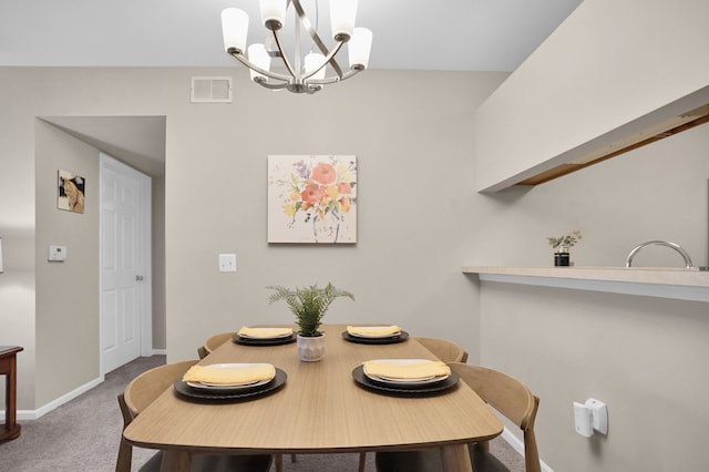 dining area featuring an inviting chandelier, carpet, visible vents, and baseboards