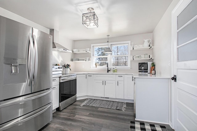 kitchen featuring open shelves, wall chimney range hood, stainless steel appliances, and a sink