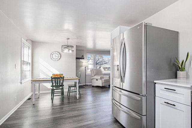 kitchen featuring baseboards, white cabinets, stainless steel fridge with ice dispenser, dark wood-style flooring, and light countertops