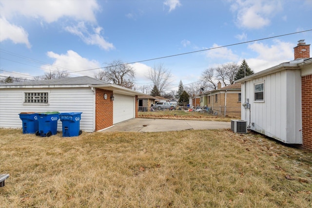 view of yard featuring a garage and an outbuilding